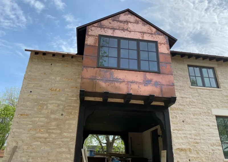 Copper metal panel facade on a stone building for Roof Repair in Weatherford